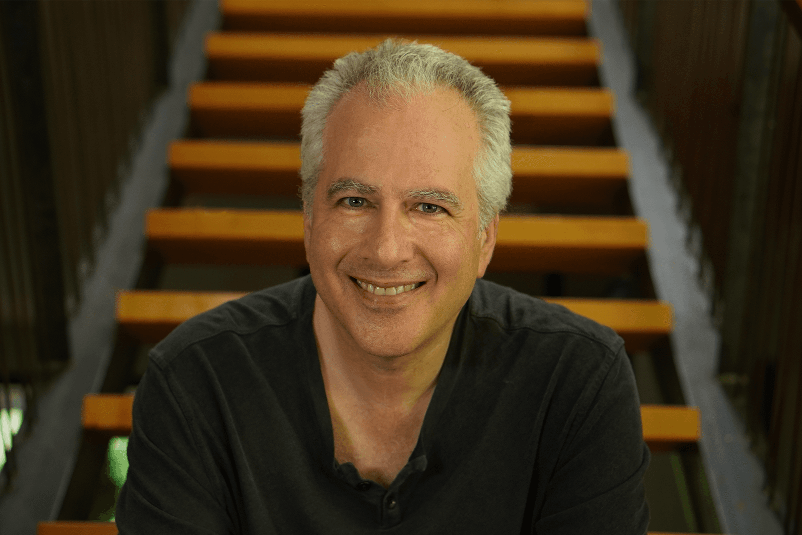 David Levine seated on a staircase